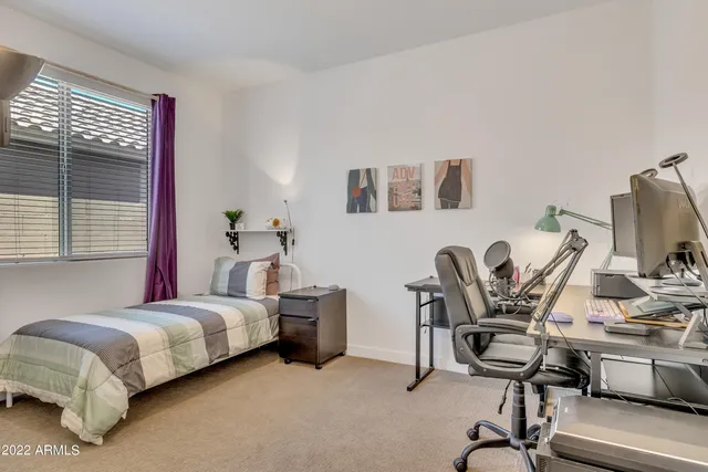 a bedroom with a bed and a desk