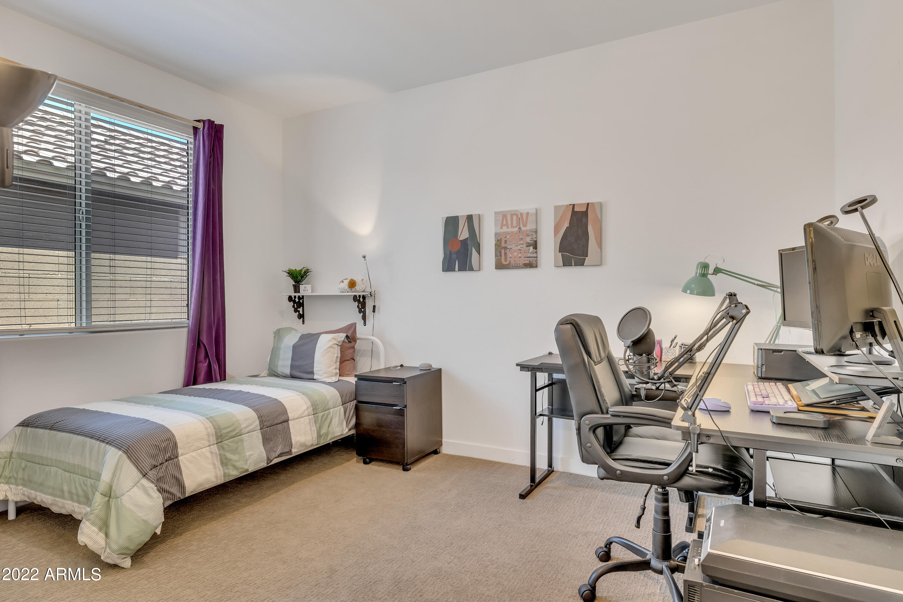 9630 West Atlantis Way Tolleson, AZ 85353 - Photo 23 of 37 a bedroom with a bed and a desk