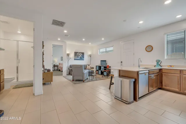 a large white kitchen with sink and furniture