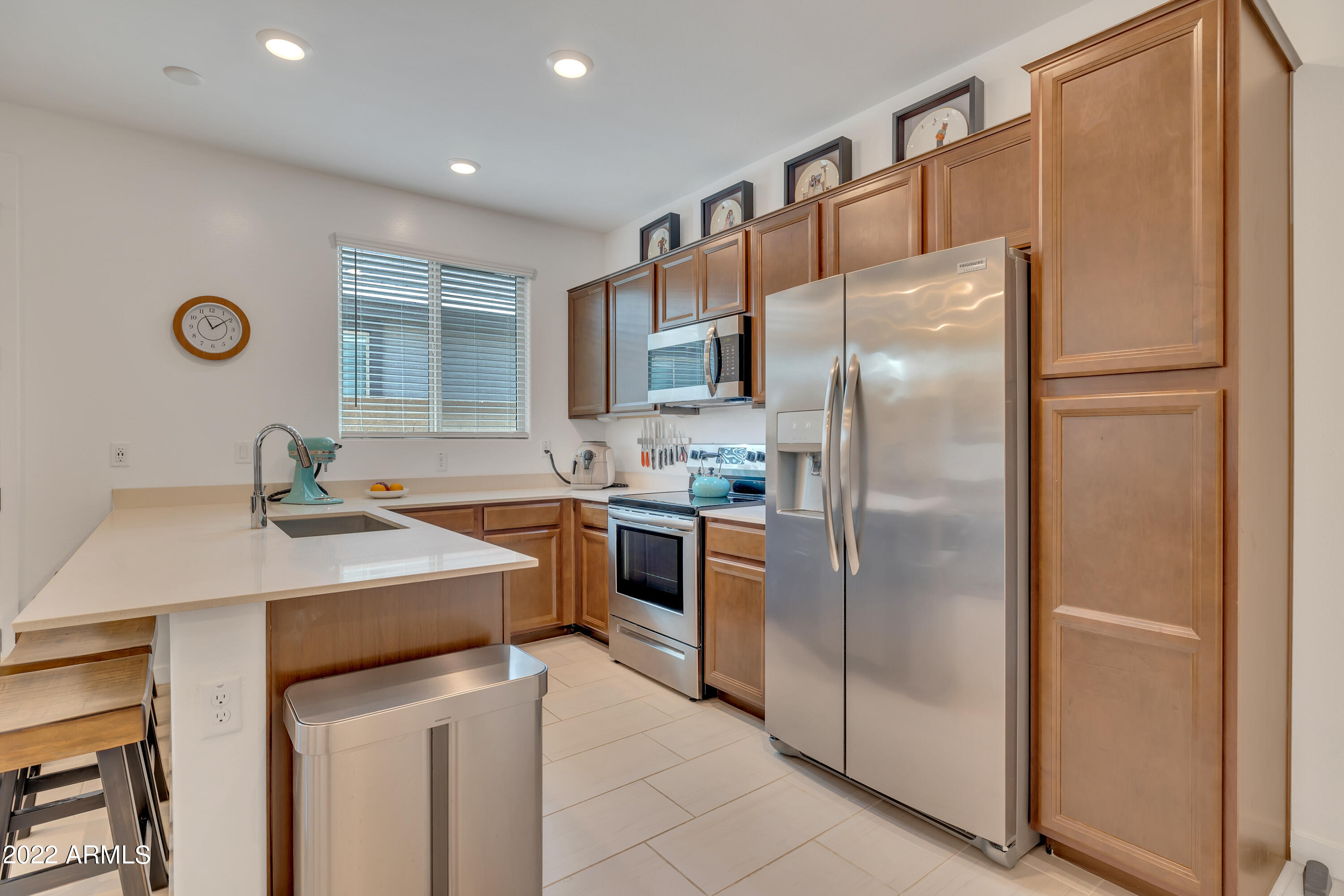 9630 West Atlantis Way Tolleson, AZ 85353 - Photo 26 of 37 a kitchen with stainless steel appliances a refrigerator and a sink