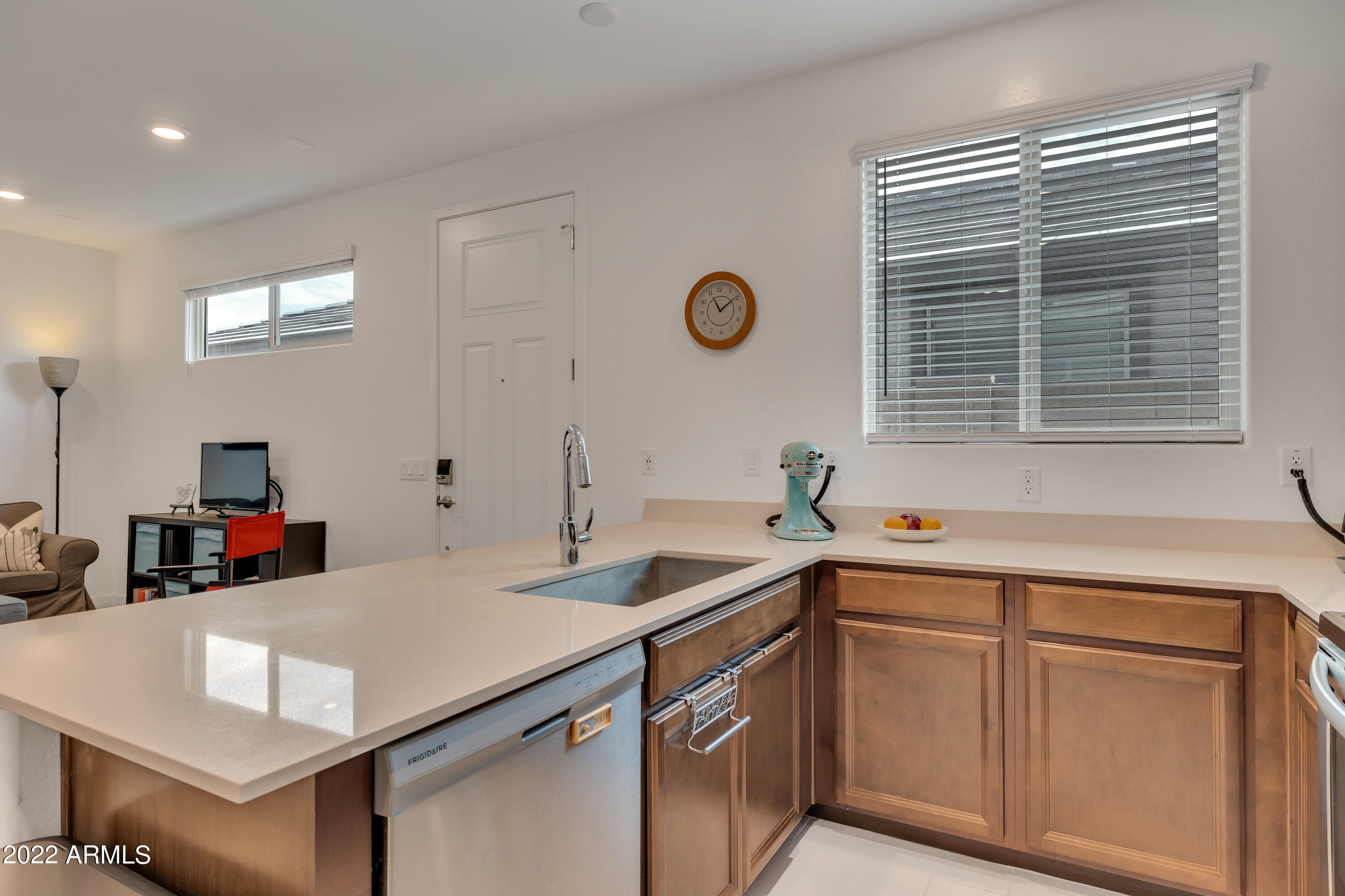 9630 West Atlantis Way Tolleson, AZ 85353 - Photo 27 of 37 a kitchen that has a sink and a stove