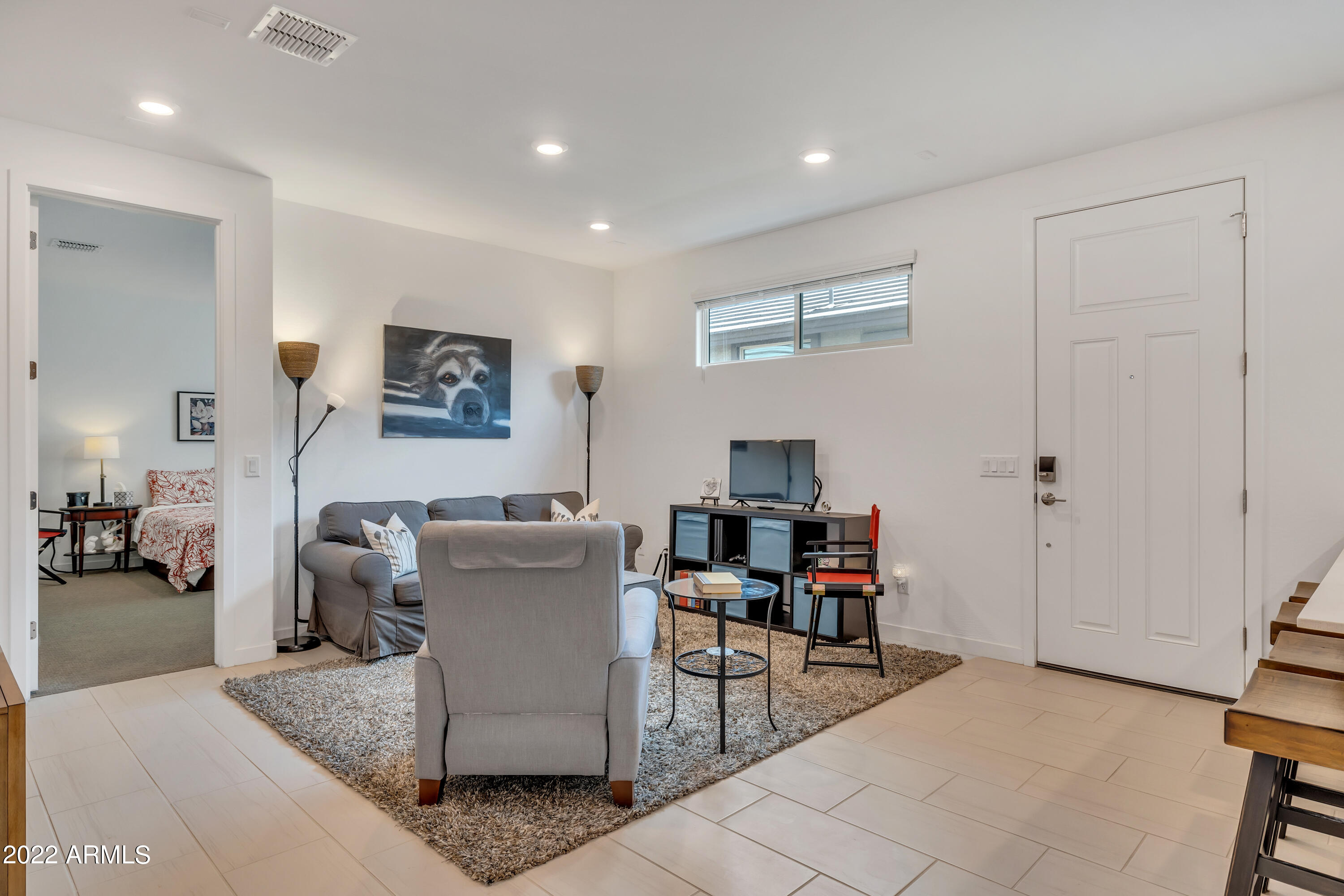 9630 West Atlantis Way Tolleson, AZ 85353 - Photo 31 of 37 a living room with furniture and a flat screen tv