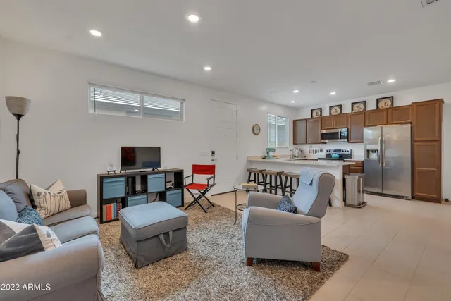 a living room with furniture and kitchen view