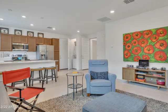 a living room with furniture and a kitchen view
