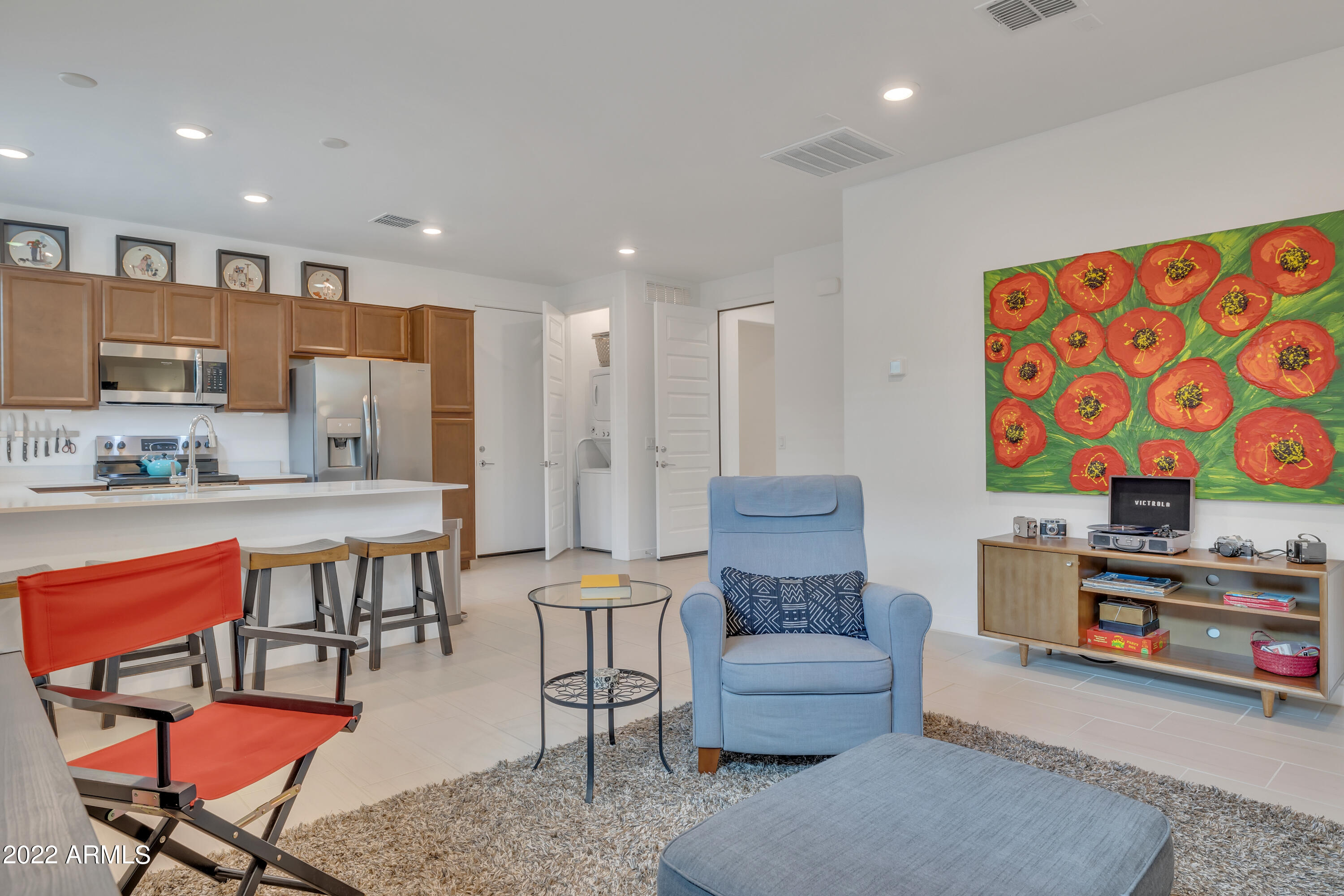 9630 West Atlantis Way Tolleson, AZ 85353 - Photo 33 of 37 a living room with furniture and a kitchen view