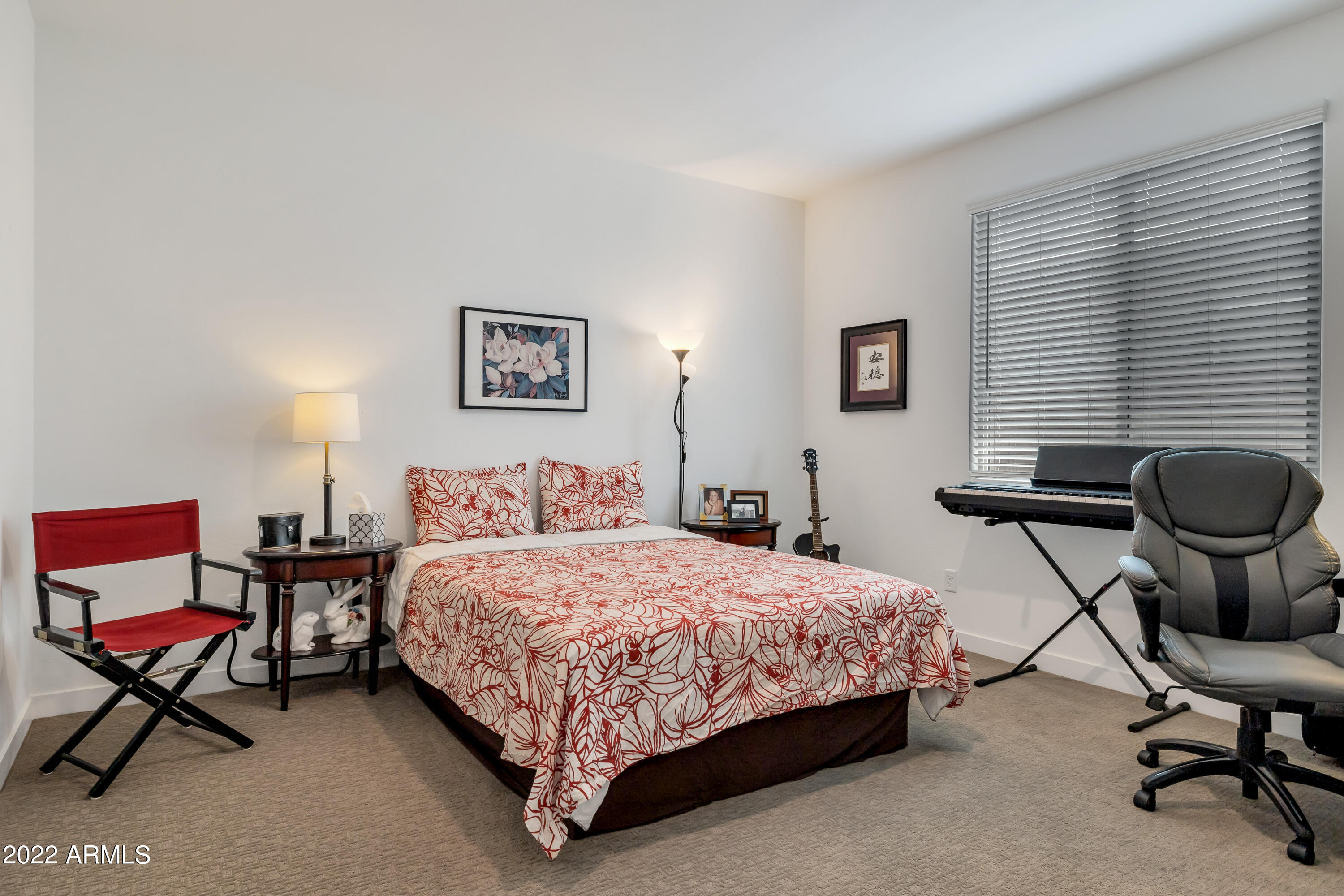 9630 West Atlantis Way Tolleson, AZ 85353 - Photo 34 of 37 a bedroom with a bed chair and a desk