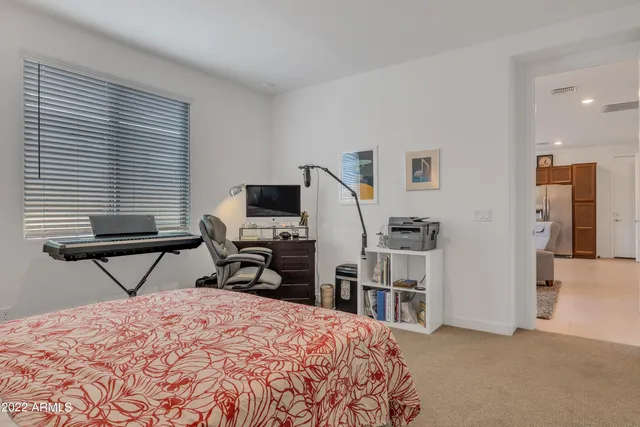 a bedroom that has a bed and a chair in it