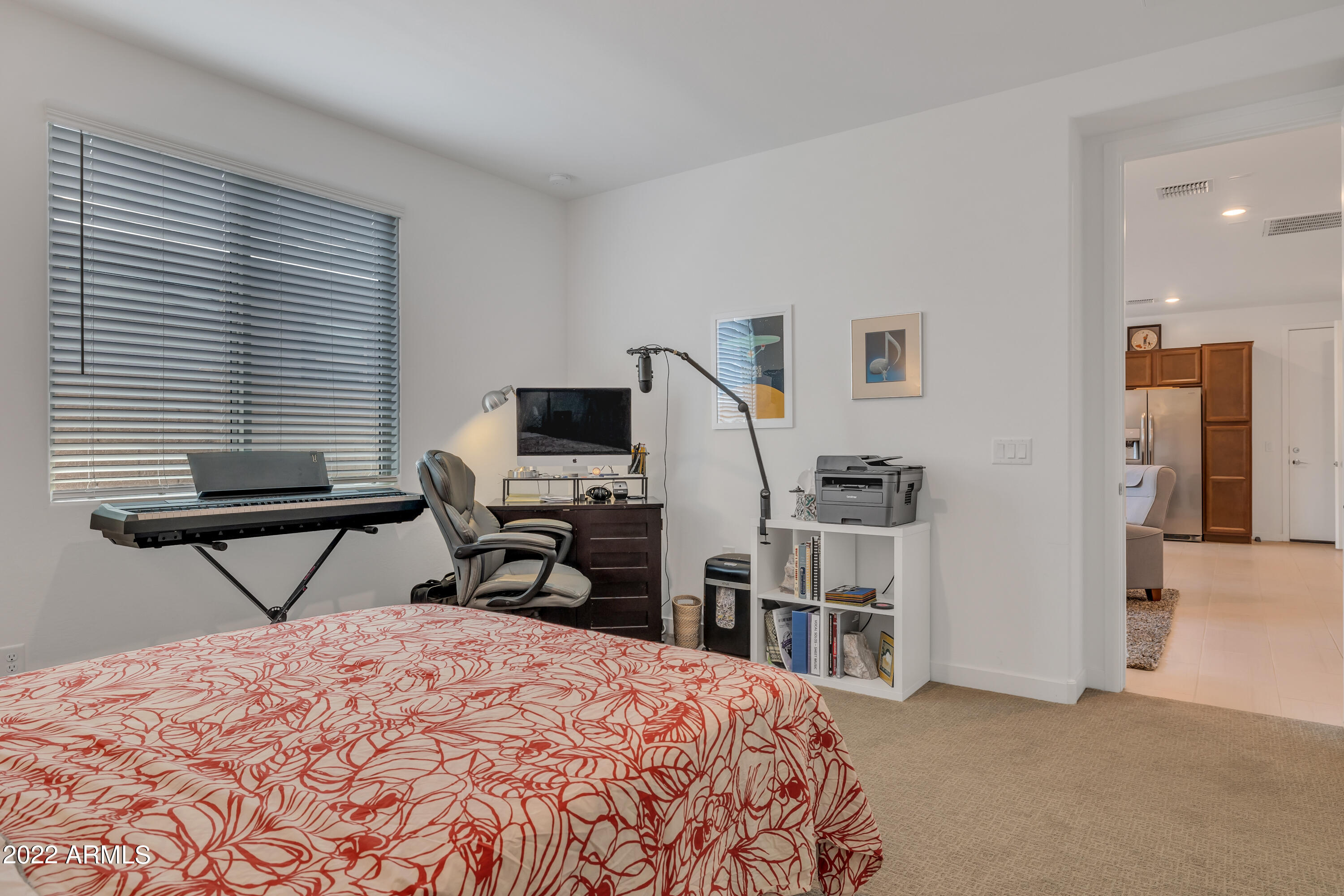 9630 West Atlantis Way Tolleson, AZ 85353 - Photo 35 of 37 a bedroom that has a bed and a chair in it