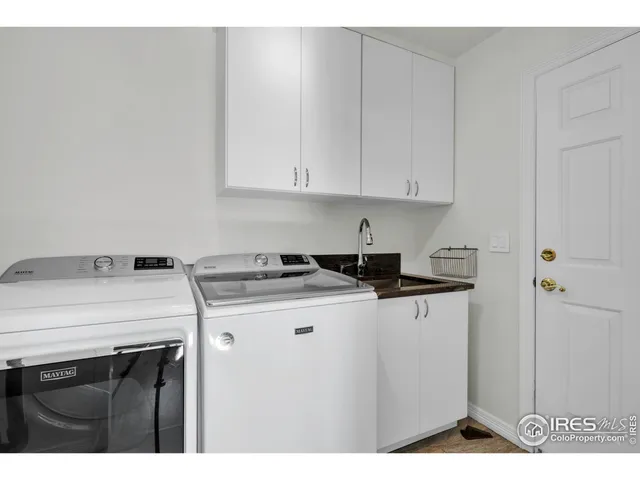a bathroom with a granite countertop sink a mirror and shower