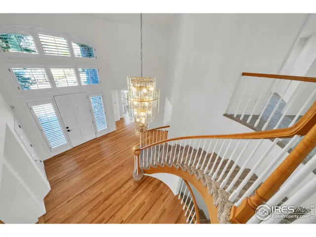 a bathroom with a granite countertop double vanity and a mirror