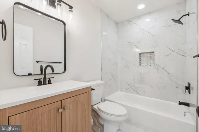 a bathroom with a sink a toilet and a bathtub