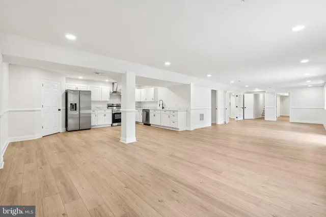 a view of a kitchen with refrigerator and a window