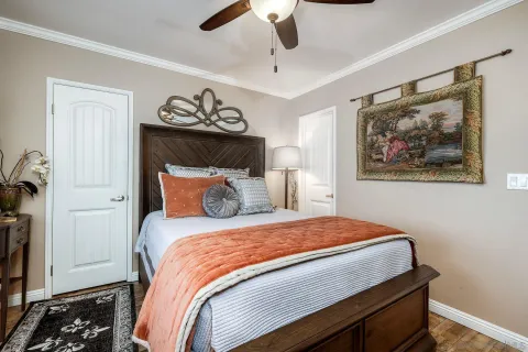 a bedroom with a bed and a chandelier