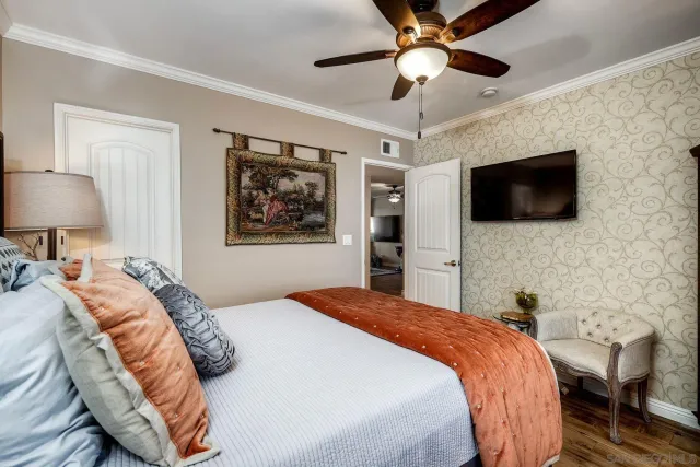 a bedroom with a bed and a flat screen tv