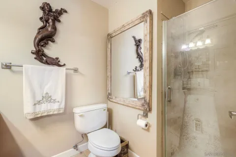 a white toilet sitting next to a bathroom sink
