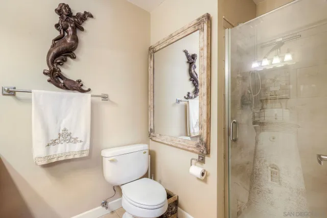 a white toilet sitting next to a bathroom sink