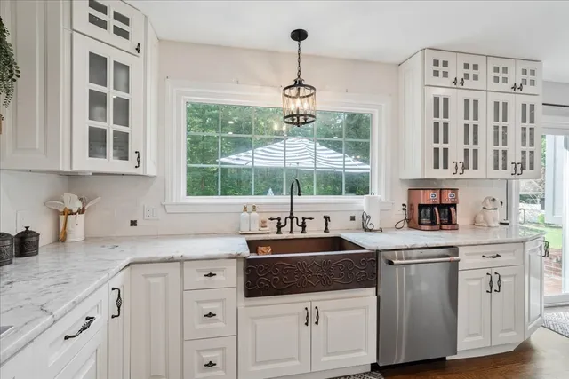 a kitchen with stainless steel appliances granite countertop a stove and cabinets