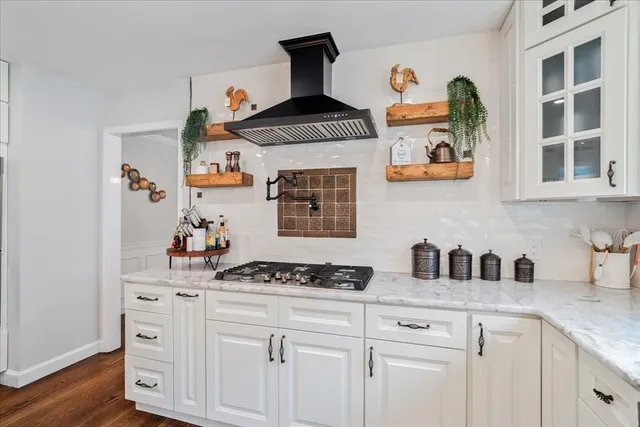 a large kitchen with granite countertop a sink cabinets and stainless steel appliances