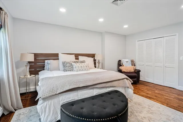 a bathroom with a granite countertop toilet a sink and a mirror