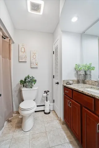 a living room with a couch chairs and a flat screen tv