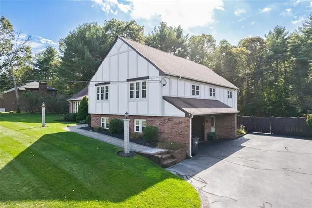 a view of a house with a yard and sitting area