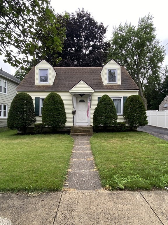 a front view of a house with a garden