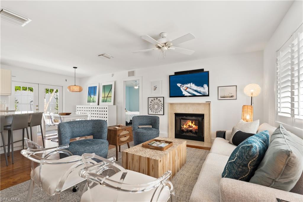 a living room with furniture a fireplace and a window