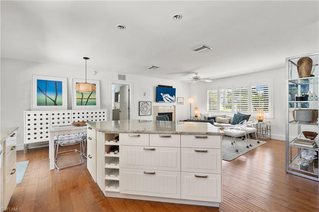 725 Central Avenue Naples, FL 34102 - Photo 2 of 10 a living room with furniture and a wooden floor