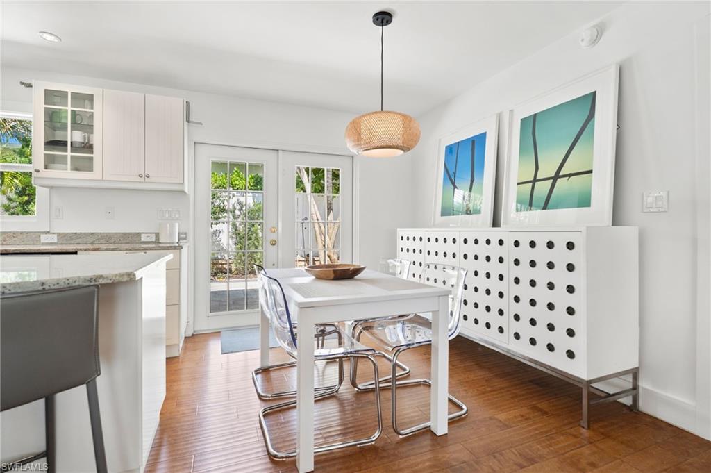 725 Central Avenue Naples, FL 34102 - Photo 4 of 10 a view of a dining room with furniture window and wooden floor