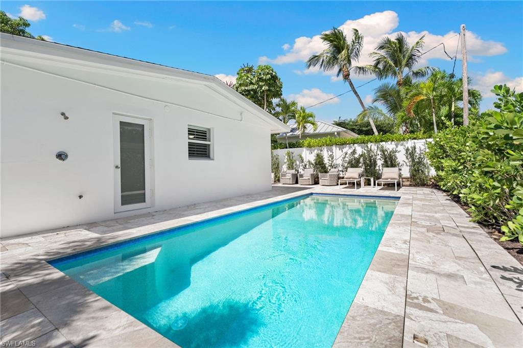 725 Central Avenue Naples, FL 34102 - Photo 9 of 10 a view of swimming pool with a yard