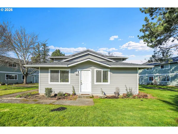 a front view of a house with a garden