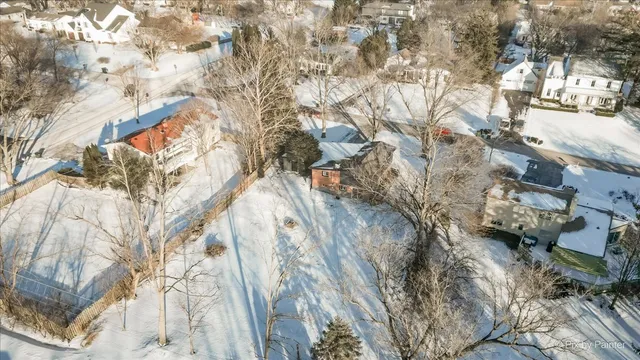 a view of a yard with snow on the road