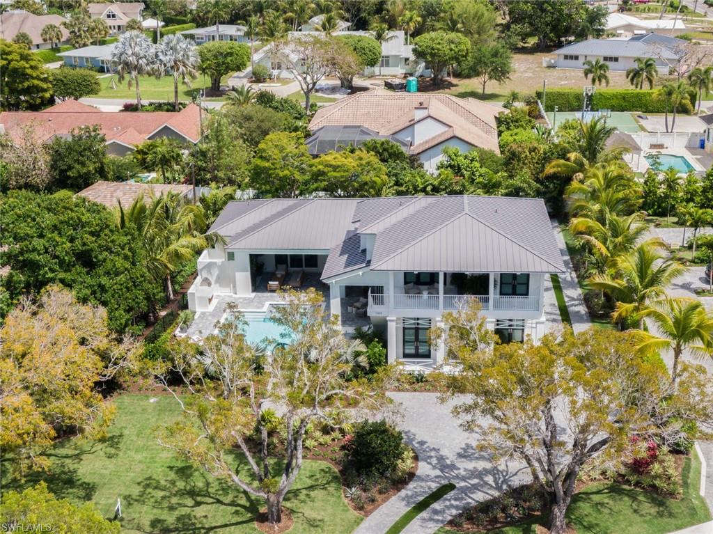 an aerial view of a house with yard and lake view