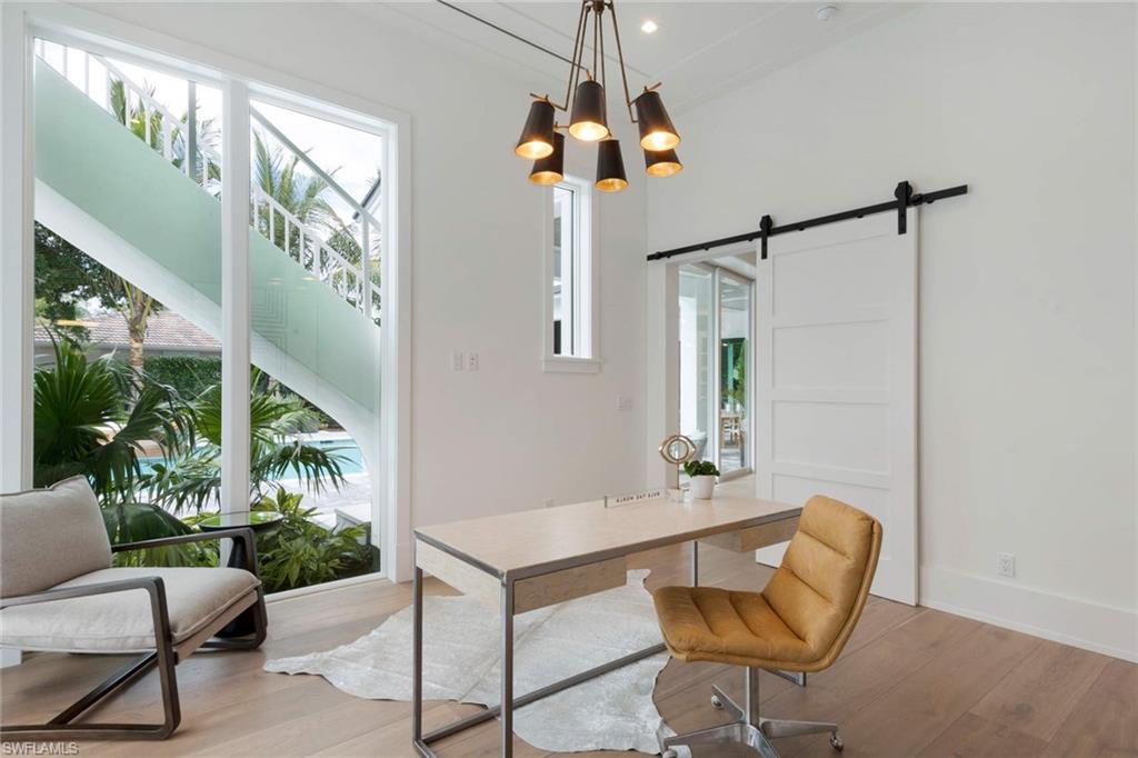 1430 Crayton Road Naples, FL 34102 - Photo 14 of 34 a dining room with furniture and a floor to ceiling window