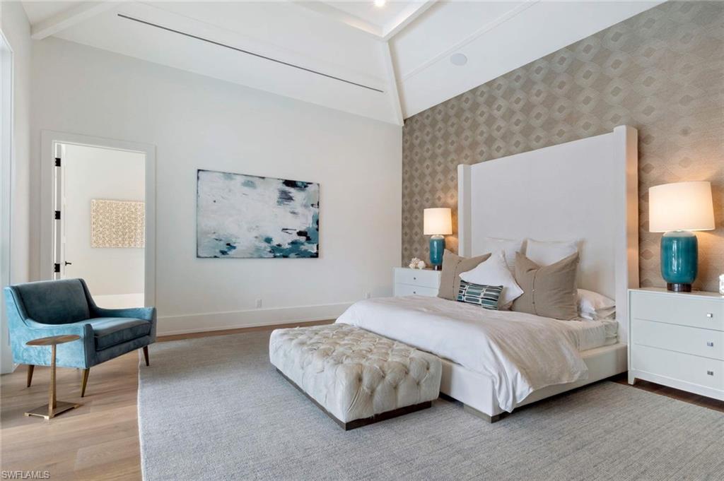 1430 Crayton Road Naples, FL 34102 - Photo 15 of 34 a bedroom with a bed and a painting on the wall