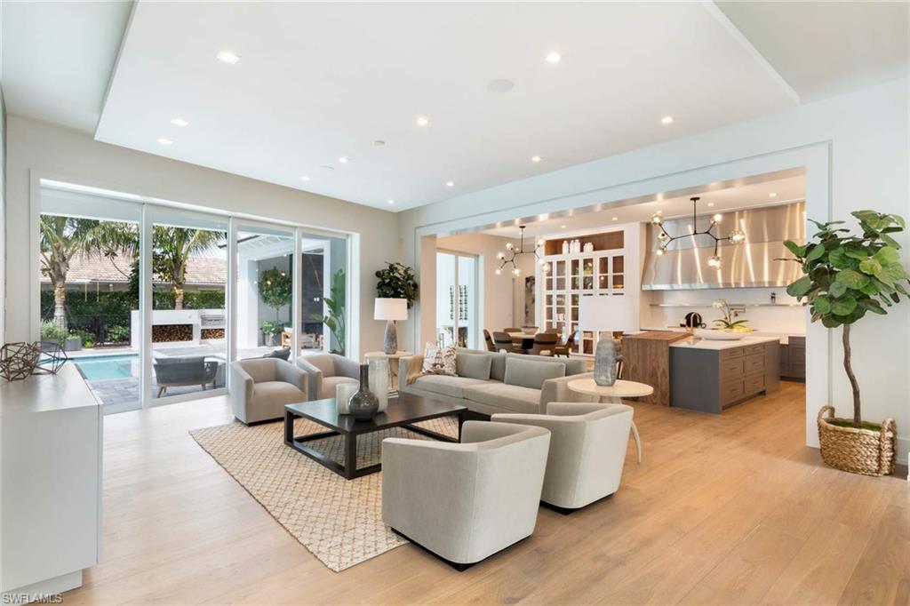 1430 Crayton Road Naples, FL 34102 - Photo 2 of 34 a living room with furniture large window and flat screen tv