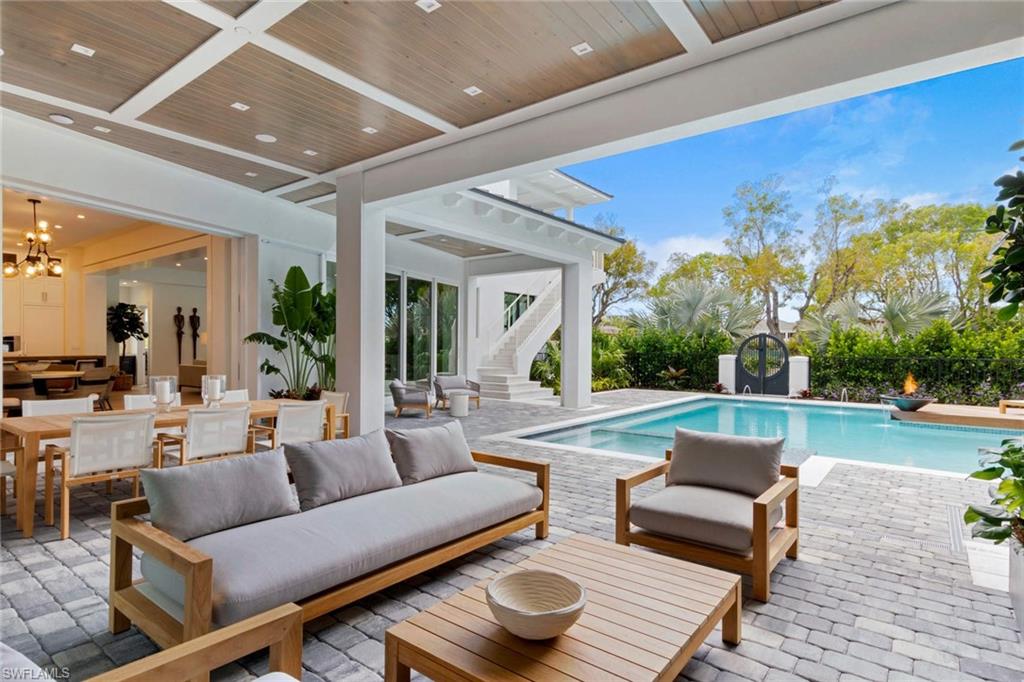 1430 Crayton Road Naples, FL 34102 - Photo 22 of 34 a view of a patio with couches and a fire pit