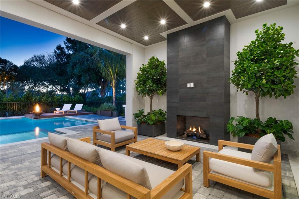 1430 Crayton Road Naples, FL 34102 - Photo 24 of 34 a outdoor living space with furniture and a fireplace