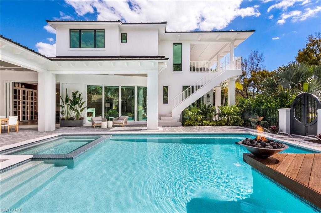 1430 Crayton Road Naples, FL 34102 - Photo 25 of 34 a view of a house with pool and sitting area