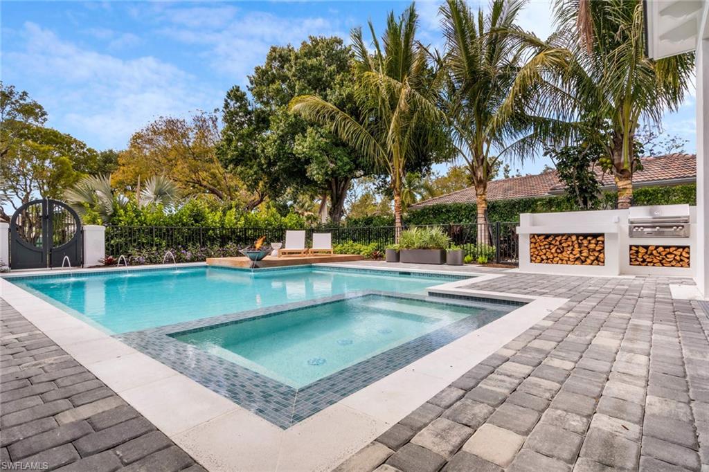 1430 Crayton Road Naples, FL 34102 - Photo 27 of 34 a view of a swimming pool with a patio