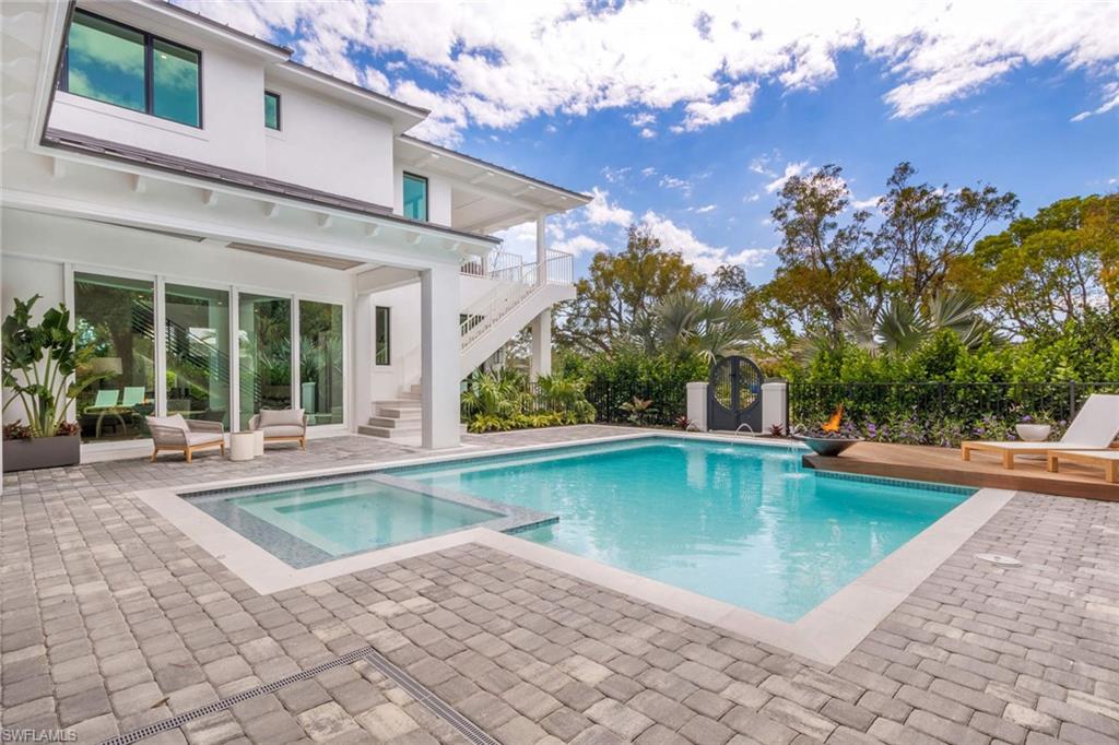 1430 Crayton Road Naples, FL 34102 - Photo 28 of 34 a view of a house with swimming pool and sitting area