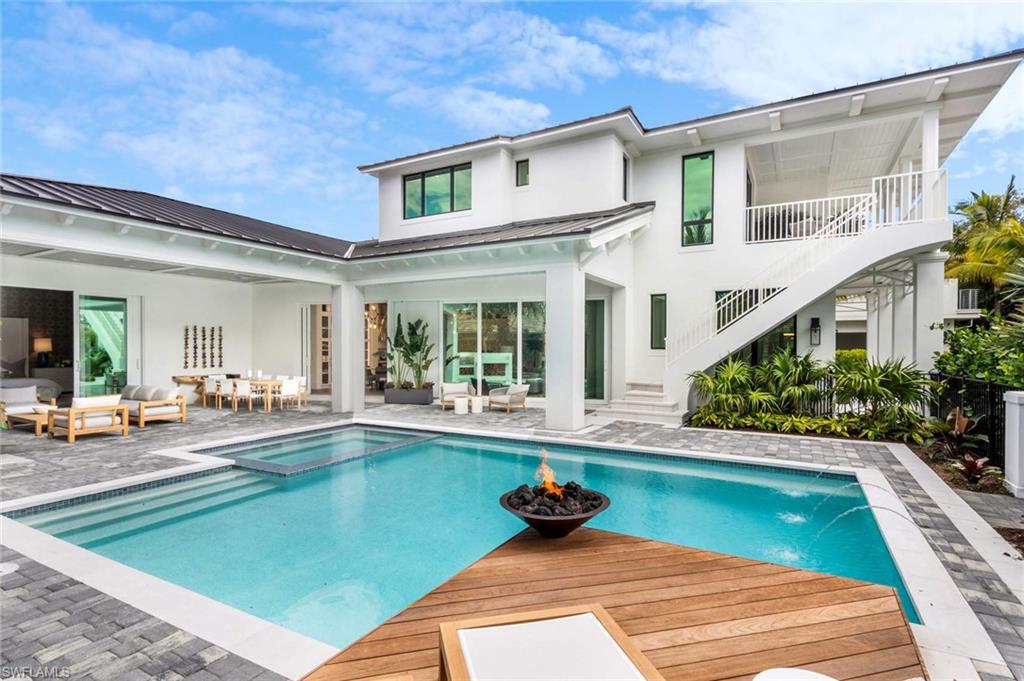 1430 Crayton Road Naples, FL 34102 - Photo 29 of 34 a view of a house with swimming pool and sitting area