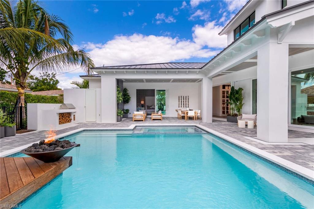 1430 Crayton Road Naples, FL 34102 - Photo 30 of 34 a view of a swimming pool with furniture