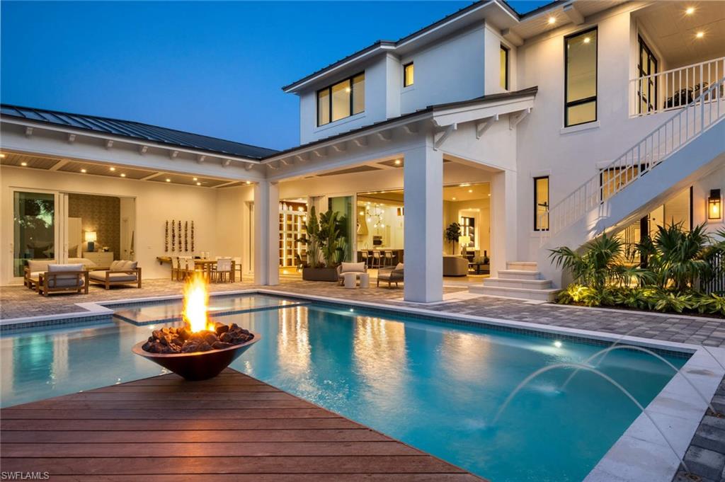 1430 Crayton Road Naples, FL 34102 - Photo 32 of 34 a view of a swimming pool with outdoor seating