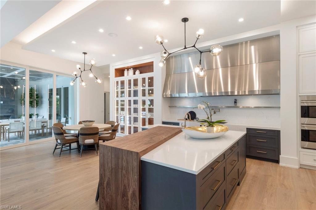 1430 Crayton Road Naples, FL 34102 - Photo 8 of 34 a kitchen with kitchen island granite countertop a sink and counter top space