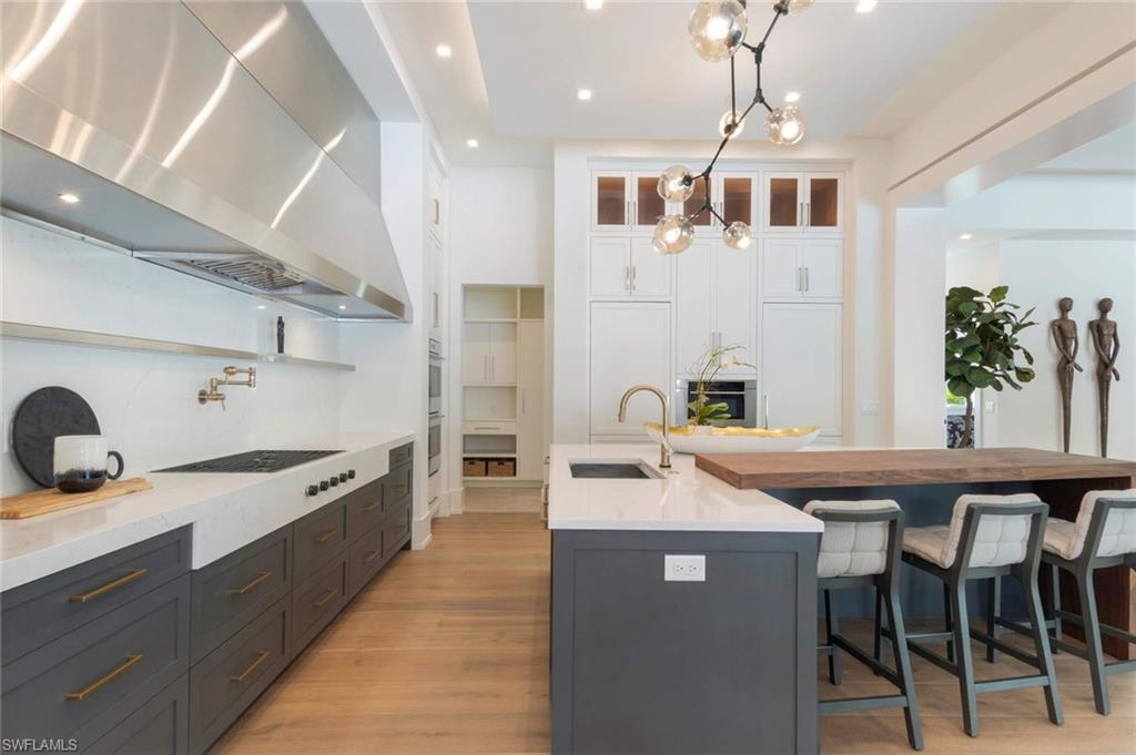 1430 Crayton Road Naples, FL 34102 - Photo 9 of 34 a kitchen with a sink and stove