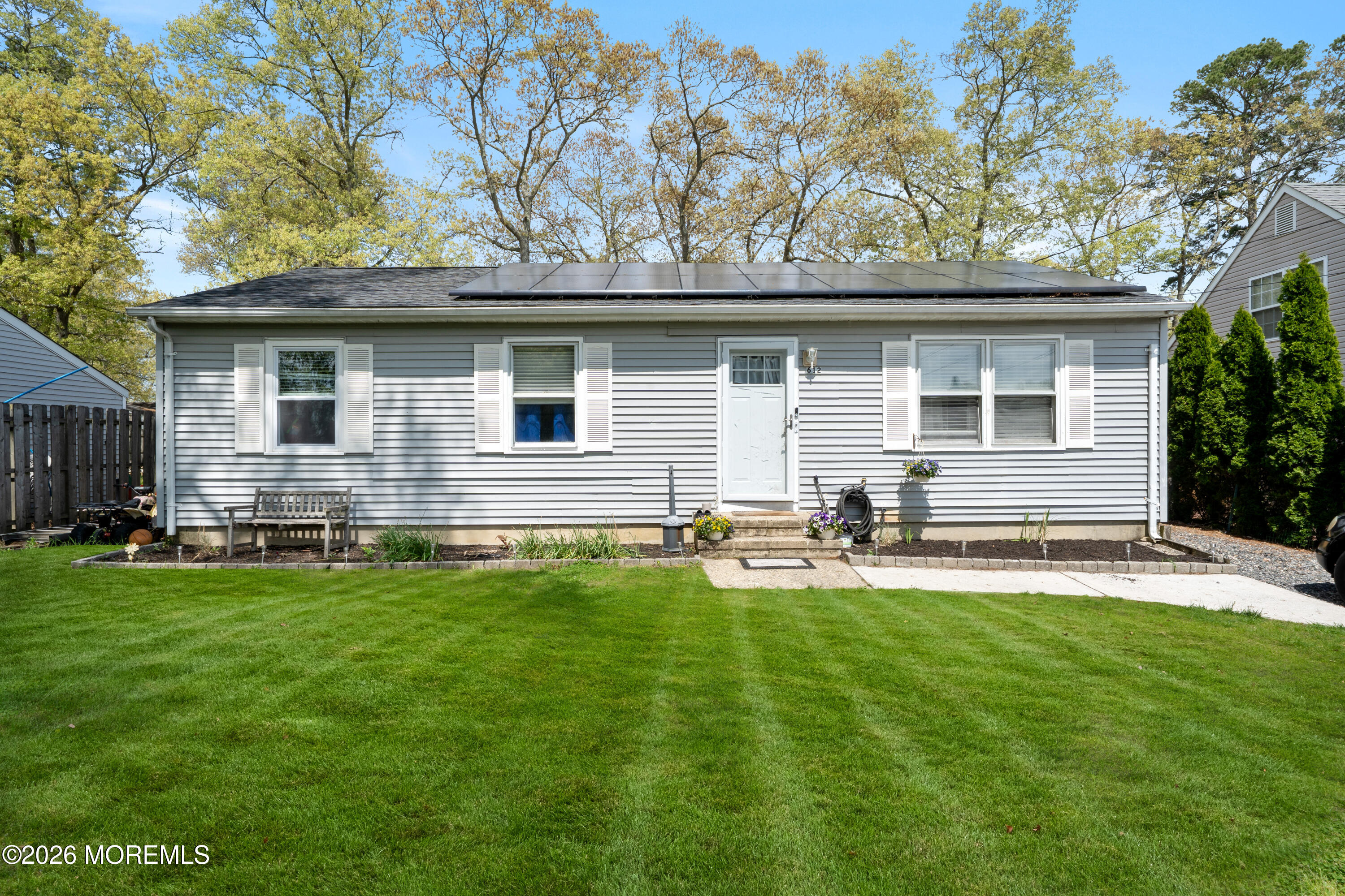 612 Nantucket Road Forked River, NJ 08731 - Photo 1 of 22 a house that has a big yard with wooden fence