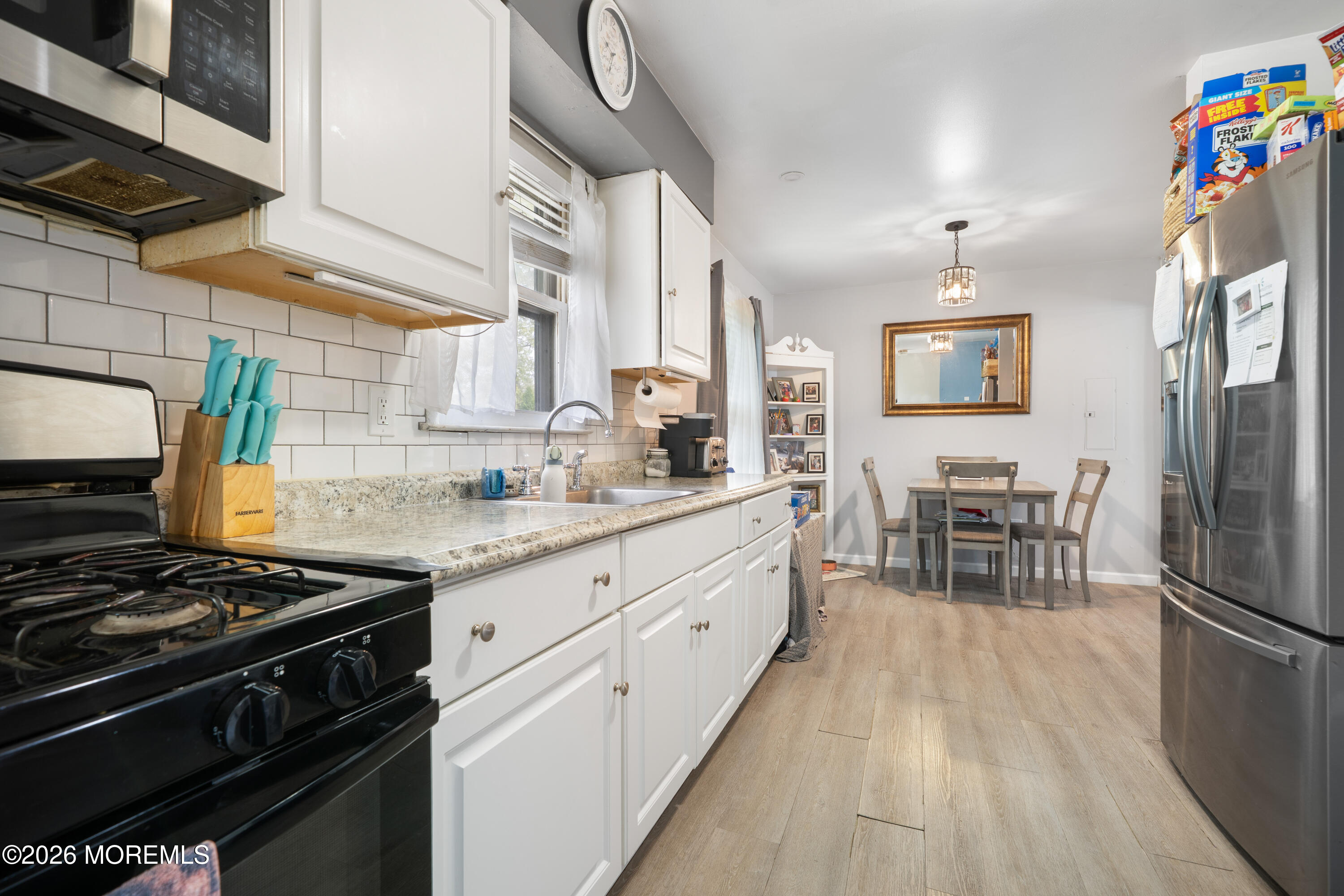 612 Nantucket Road Forked River, NJ 08731 - Photo 5 of 22 a kitchen with stainless steel appliances a stove a sink dishwasher and cabinets with wooden floor
