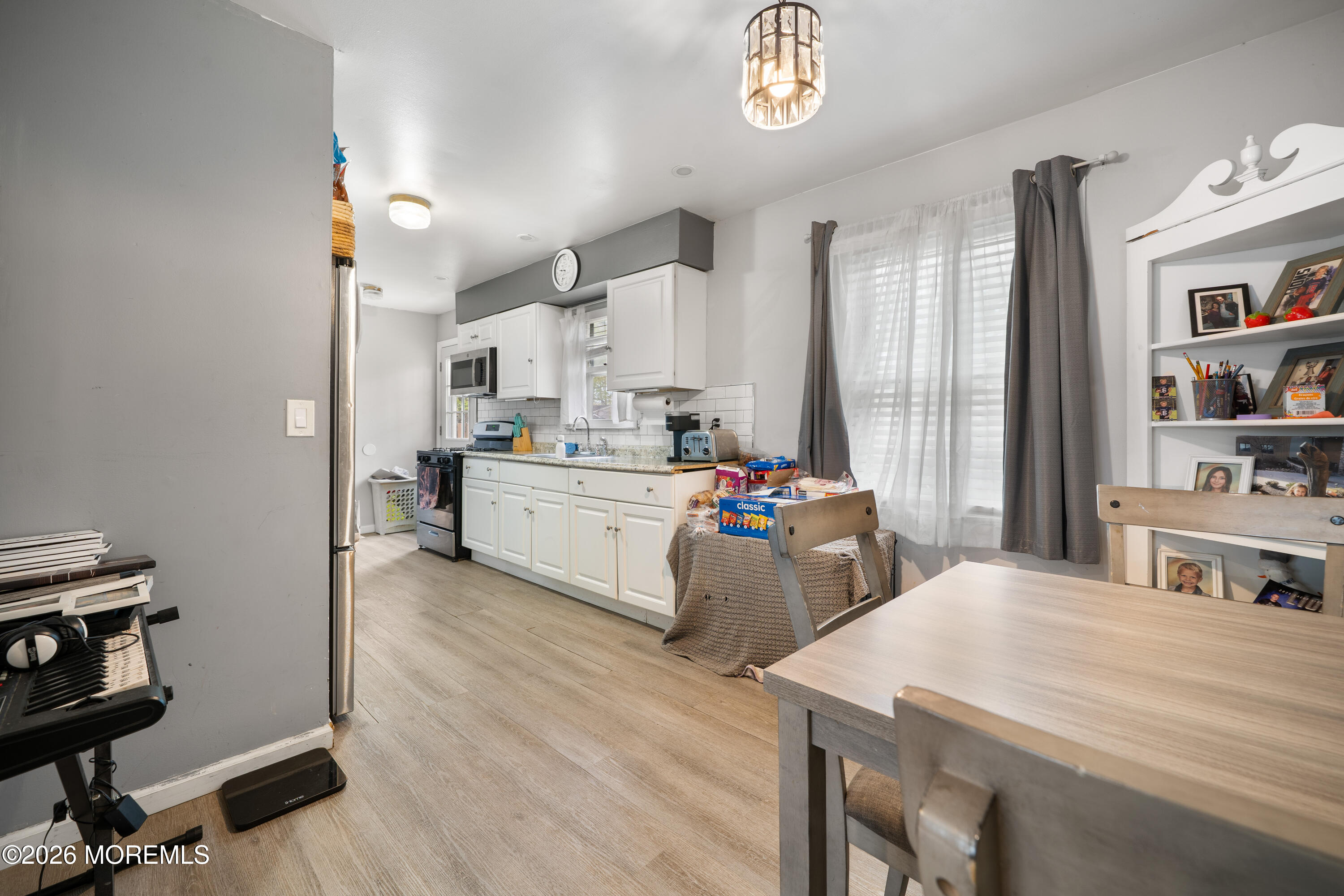 612 Nantucket Road Forked River, NJ 08731 - Photo 7 of 22 a living room with kitchen island furniture and a wooden floor