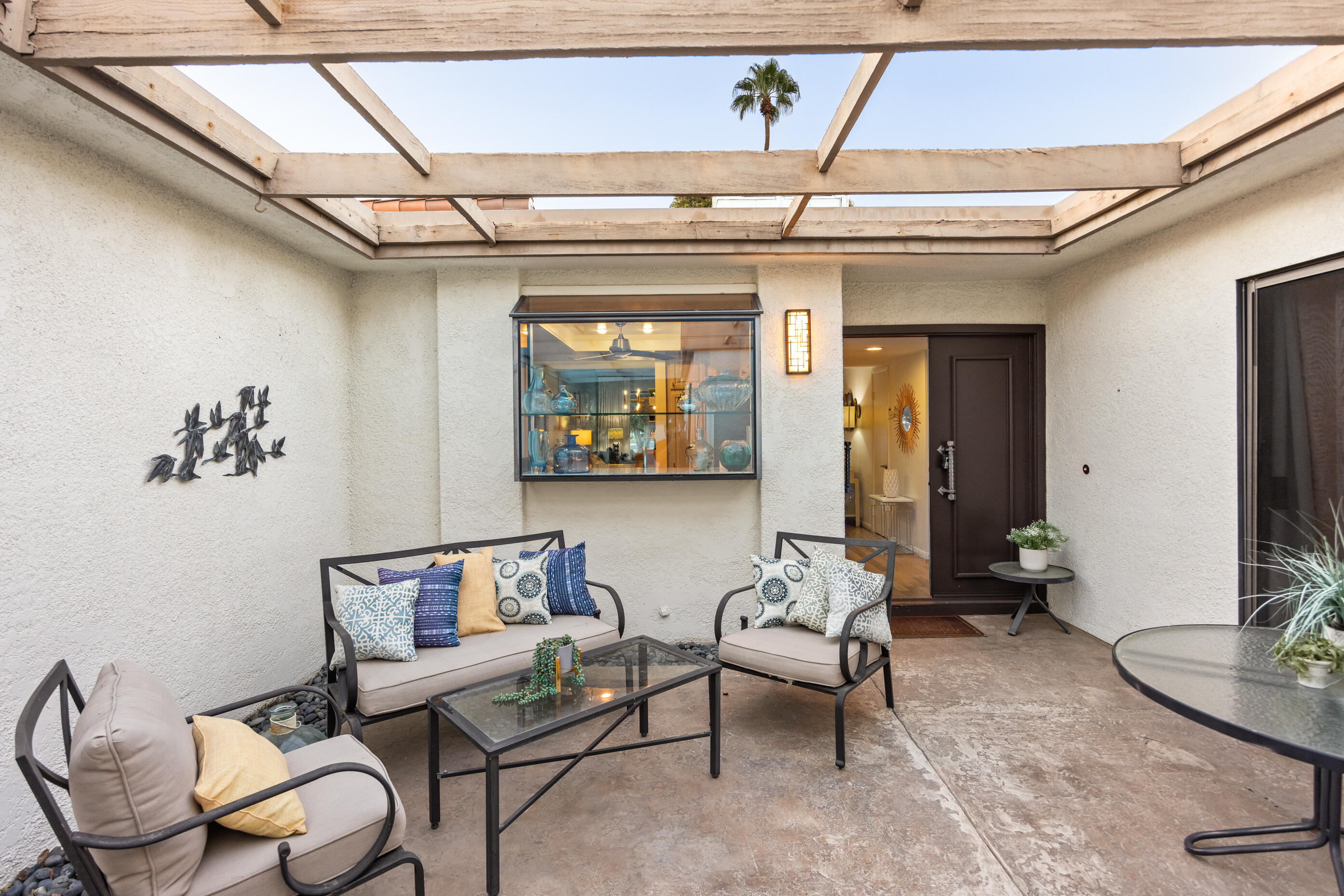 60 El Toro Drive Rancho Mirage, CA 92270 - Photo 32 of 38 a living room with furniture a rug and a window